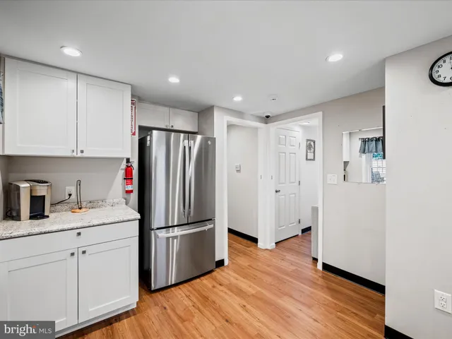 a kitchen with stainless steel appliances granite countertop a sink dishwasher and cabinets with wooden floor