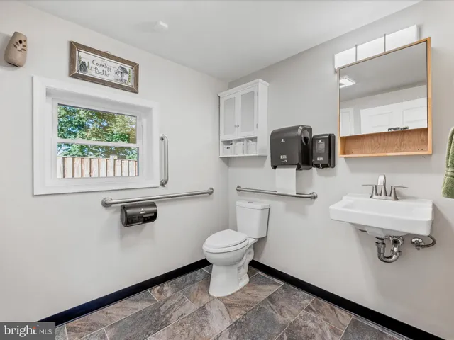 a bathroom with a glass shower door and mirror