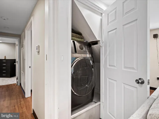 a kitchen with granite countertop a stove top oven microwave and refrigerator