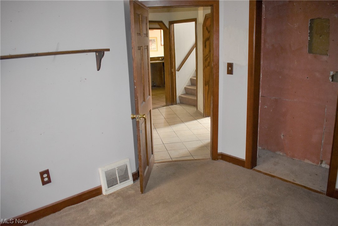 8718 Freedom Road Windham, OH 44288 - Photo 14 of 20 Hallway with light tile floors