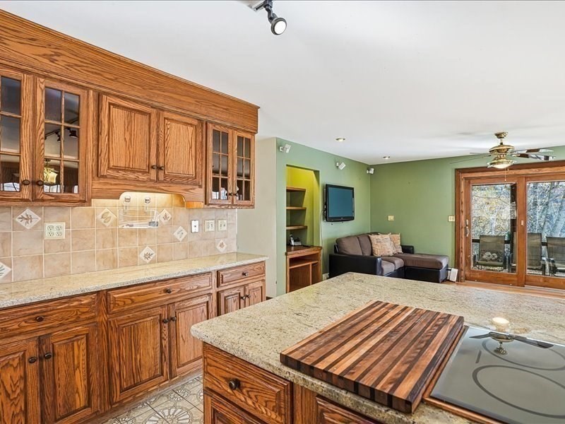 15 North Cove Road Sterling, MA 01564 - Photo 18 of 37 a large kitchen with kitchen island a stove a sink and dishwasher wooden cabinets with granite countertops