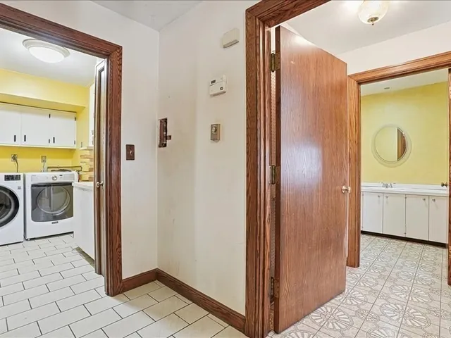a bathroom with a granite countertop shower a sink and a mirror