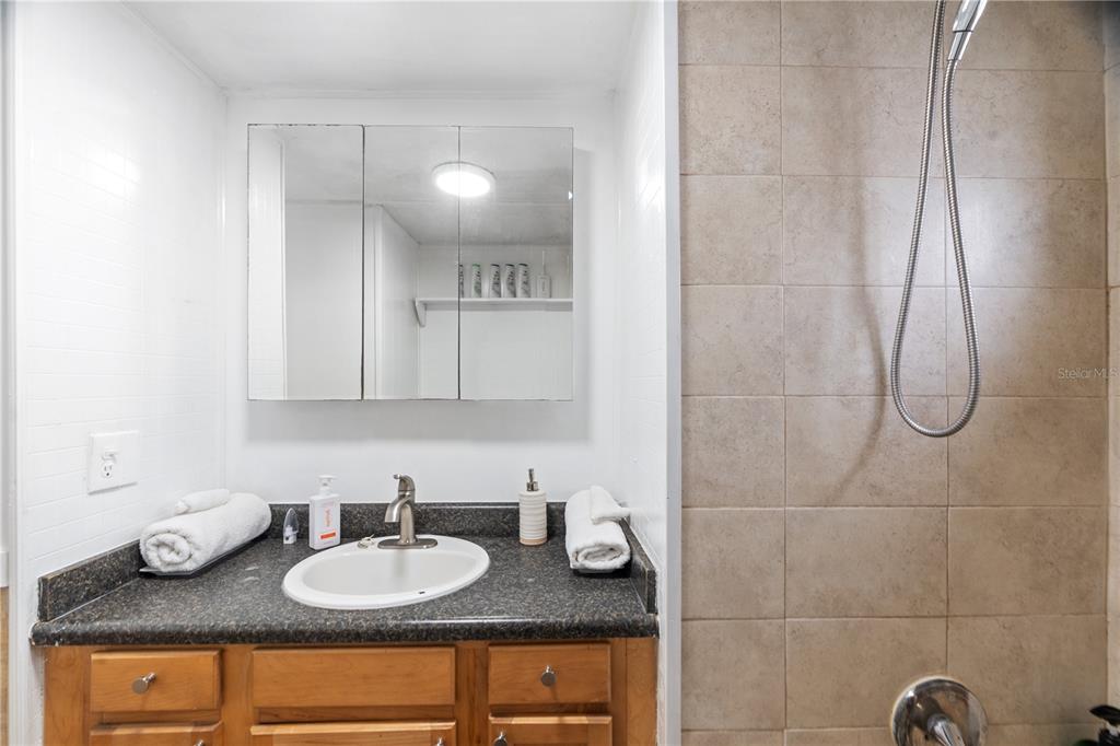 6501 Clark Street Hudson, FL 34667 - Photo 8 of 27 a bathroom with a granite countertop sink and a mirror