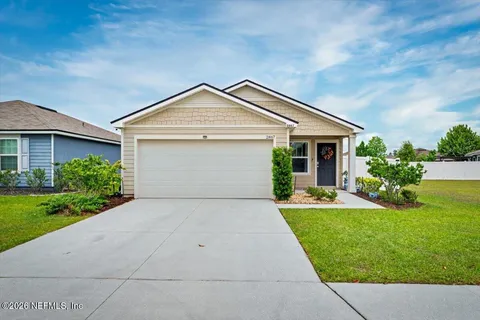 a front view of house with yard and green space