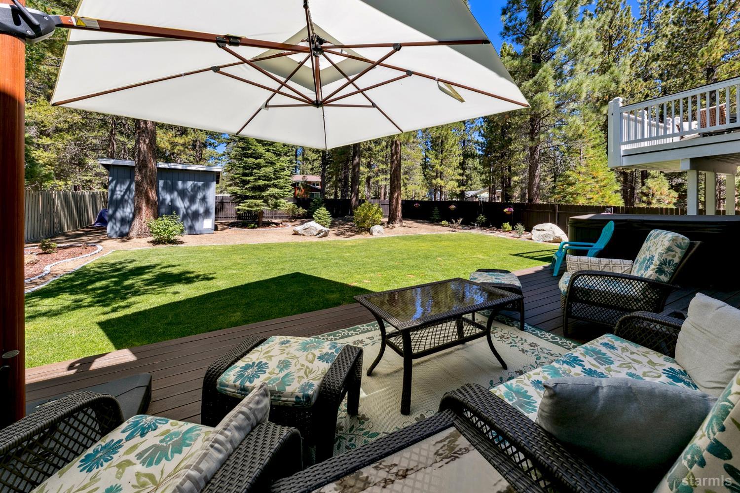 1836 Grizzly Mountain Drive South Lake Tahoe, CA 96150 - Photo 22 of 40 a view of a patio with table and chairs under an umbrella