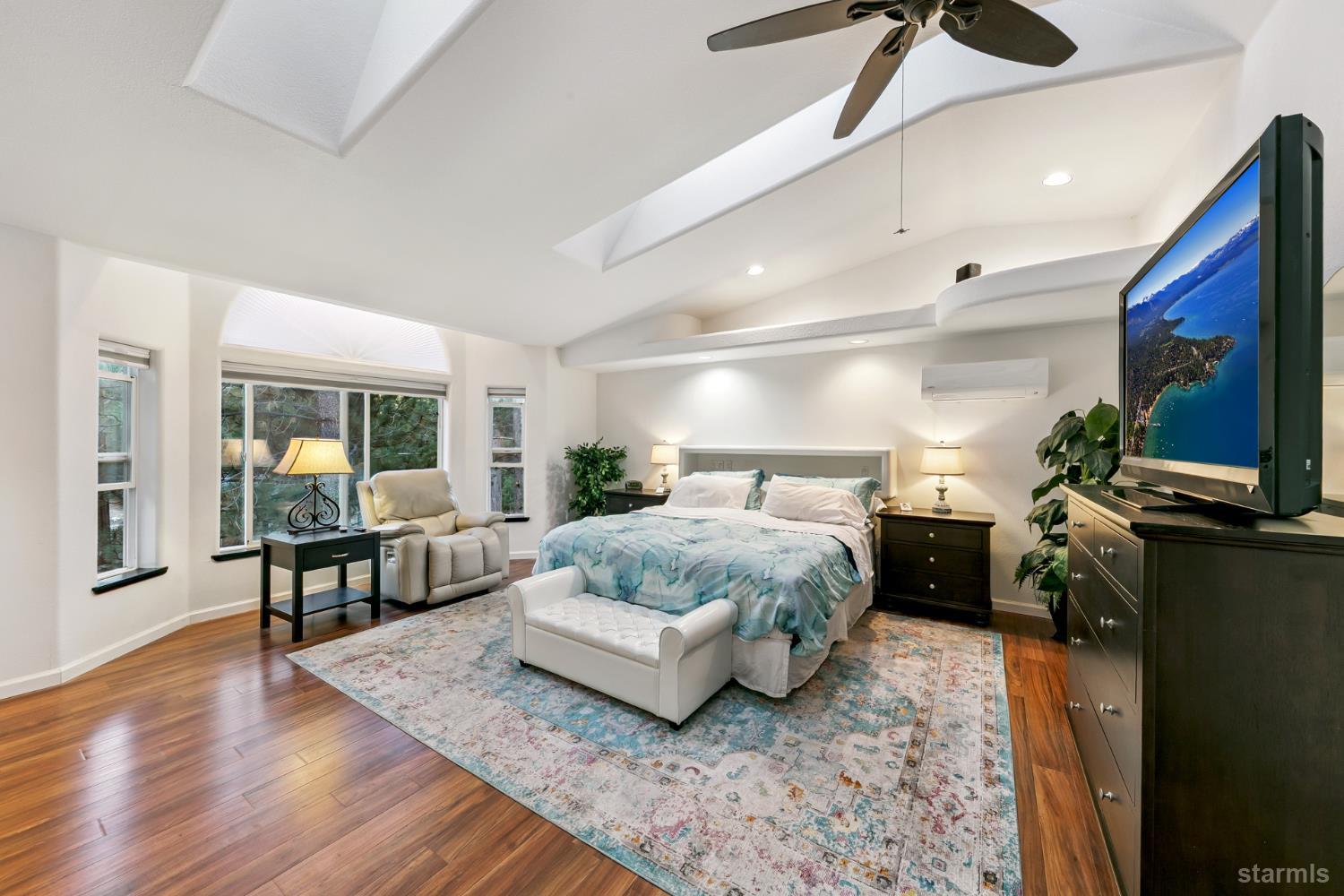 1836 Grizzly Mountain Drive South Lake Tahoe, CA 96150 - Photo 27 of 40 a spacious bedroom with a bed and wooden floor