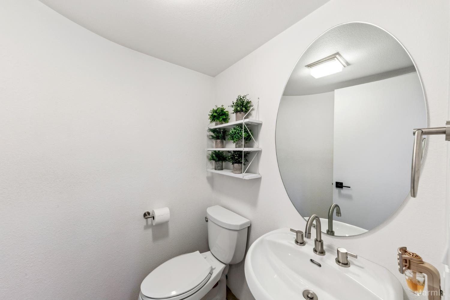 1836 Grizzly Mountain Drive South Lake Tahoe, CA 96150 - Photo 29 of 40 a bathroom with a toilet sink and mirror