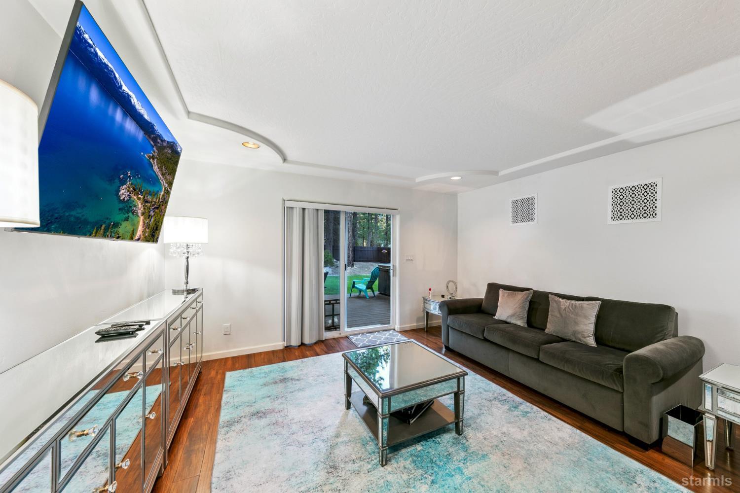 1836 Grizzly Mountain Drive South Lake Tahoe, CA 96150 - Photo 31 of 40 a living room with furniture and a flat screen tv