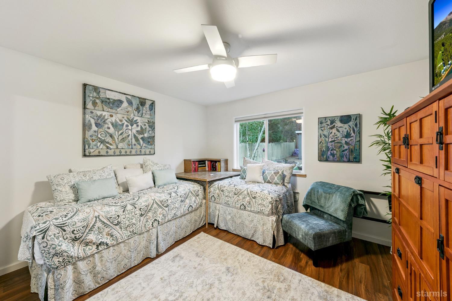 1836 Grizzly Mountain Drive South Lake Tahoe, CA 96150 - Photo 34 of 40 a living room with couches painting on the wall and a large window