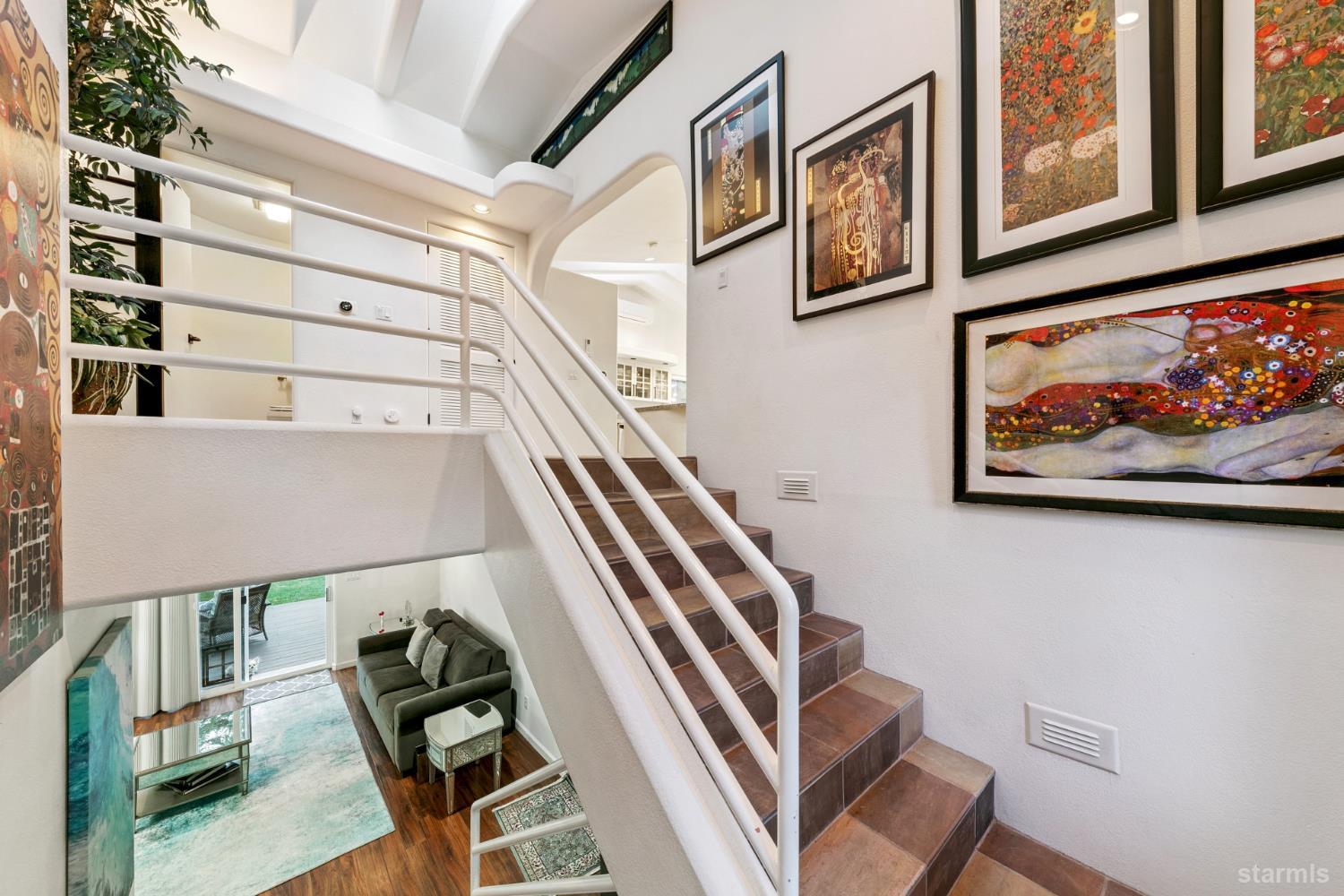 1836 Grizzly Mountain Drive South Lake Tahoe, CA 96150 - Photo 5 of 40 a view of staircase with lots of frames on wall and a painting