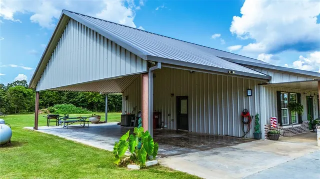 a open kitchen with stainless steel appliances granite countertop a sink dishwasher a dining table and chairs with wooden floor
