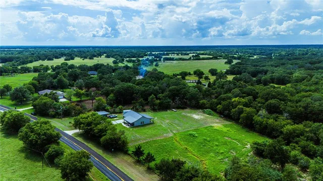 a front view of house with yard patio and green space