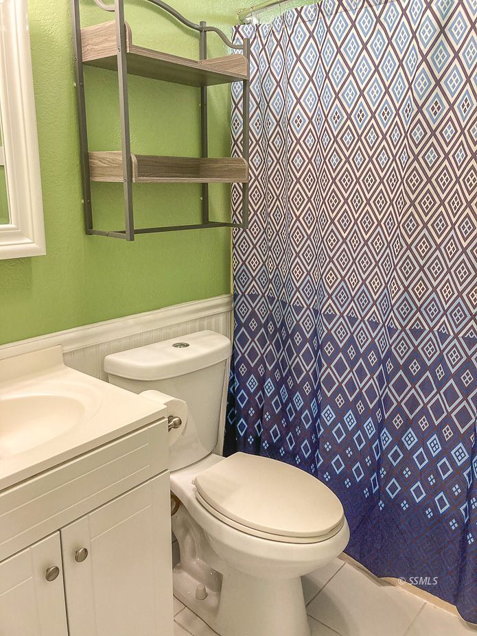 216 West Boston Avenue Ridgecrest, CA 93555 - Photo 20 of 36 a bathroom with a toilet and a sink