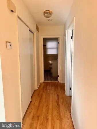 a view of a hallway with wooden floor