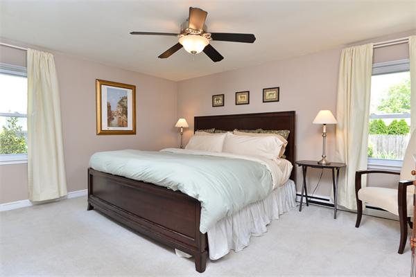 140 Governors Road Quincy, MA 02169 - Photo 13 of 24 a bedroom with a bed chandelier and a window