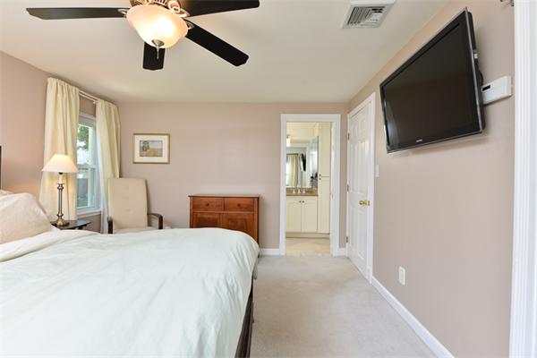 140 Governors Road Quincy, MA 02169 - Photo 14 of 24 a bedroom with a bed and a flat tv screen on dresser