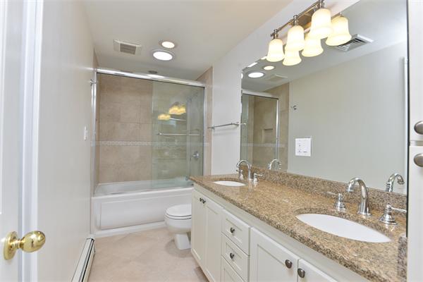 140 Governors Road Quincy, MA 02169 - Photo 15 of 24 a bathroom with a granite countertop sink a toilet and bathtub