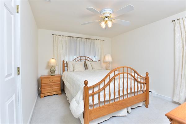 140 Governors Road Quincy, MA 02169 - Photo 16 of 24 a bedroom with a bed and a chandelier