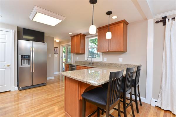 140 Governors Road Quincy, MA 02169 - Photo 9 of 24 a kitchen with a table chairs refrigerator and microwave