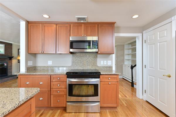 140 Governors Road Quincy, MA 02169 - Photo 10 of 24 a kitchen with granite countertop a stove and a microwave
