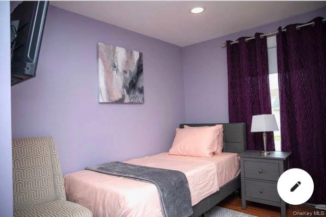 36 West Saltaire Road Lindenhurst, NY 11757 - Photo 3 of 8 a bedroom with a bed and a lamp on the dresser