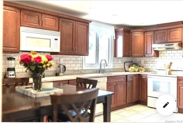 a kitchen with stainless steel appliances granite countertop a sink dishwasher and cabinets with wooden floor
