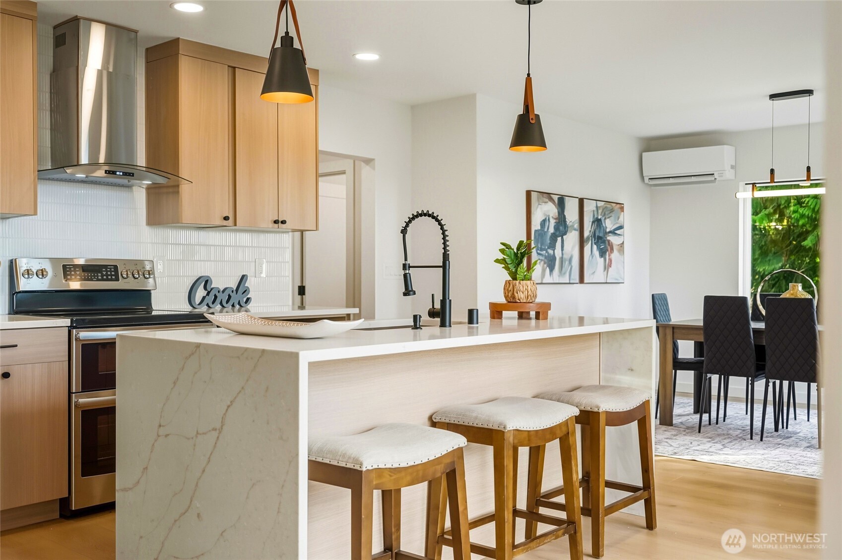 16126 Tiger Mountain Road Southeast Issaquah, WA 98027 - Photo 12 of 38 a kitchen with a table chairs microwave and cabinets