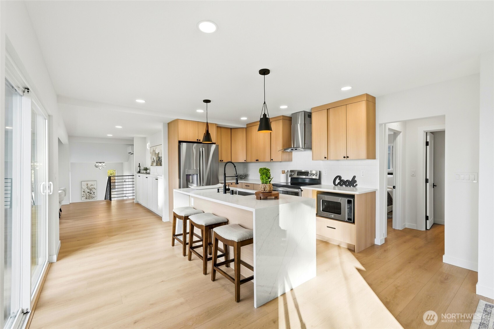 16126 Tiger Mountain Road Southeast Issaquah, WA 98027 - Photo 13 of 38 a large kitchen with lots of counter space dining table and stainless steel appliances
