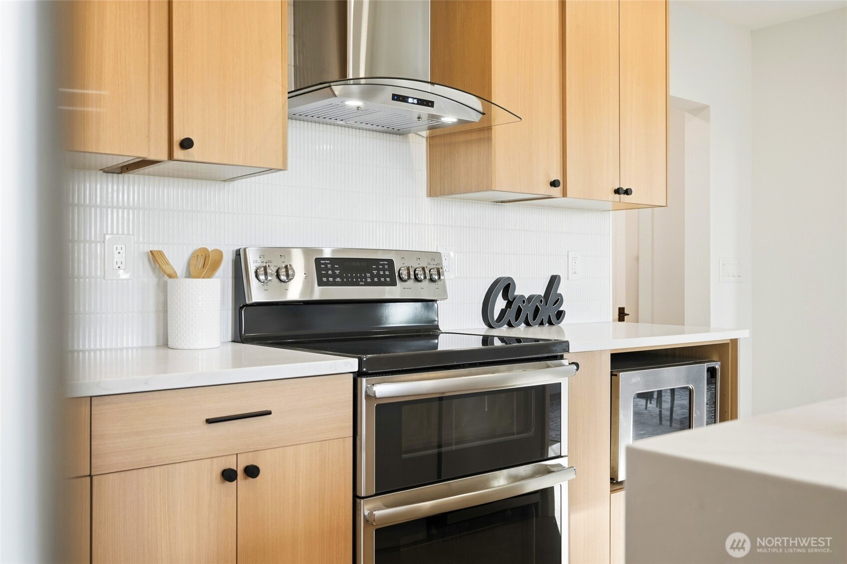 16126 Tiger Mountain Road Southeast Issaquah, WA 98027 - Photo 17 of 38 a kitchen with stainless steel appliances granite countertop a stove and a white cabinets