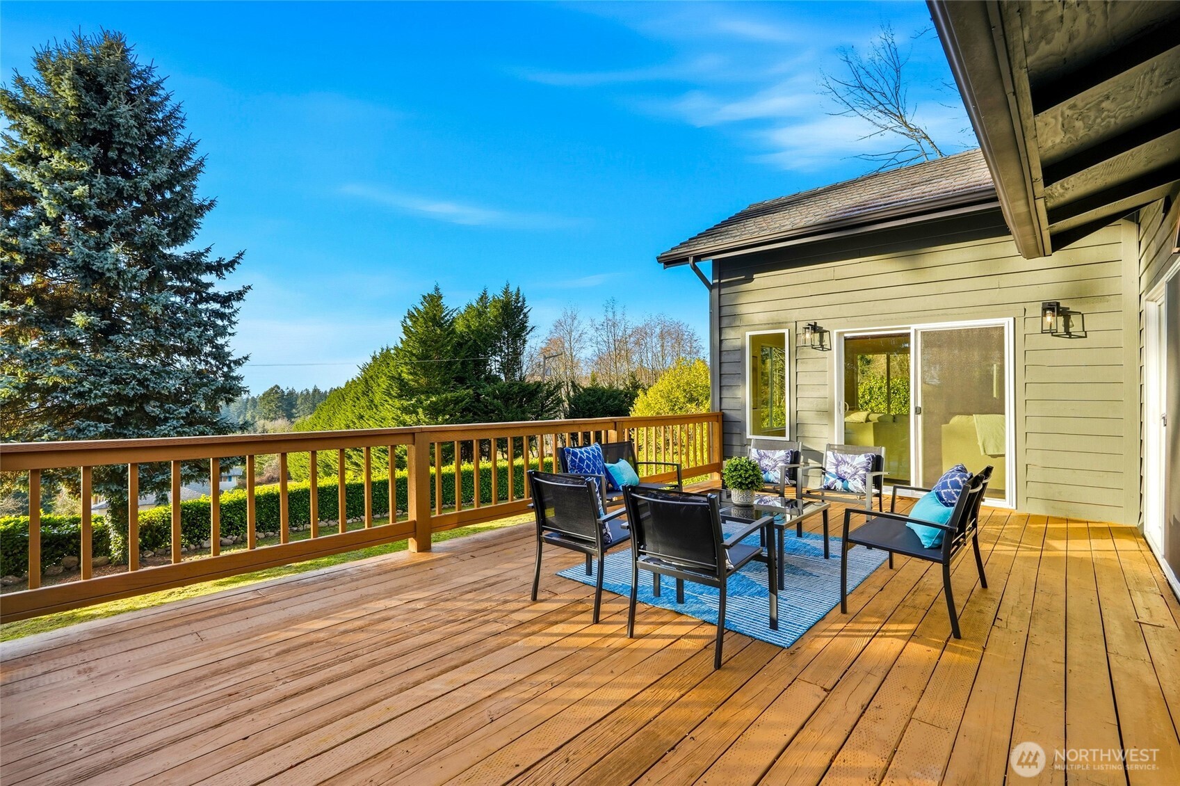 16126 Tiger Mountain Road Southeast Issaquah, WA 98027 - Photo 21 of 38 a view of a balcony with chairs and wooden floor