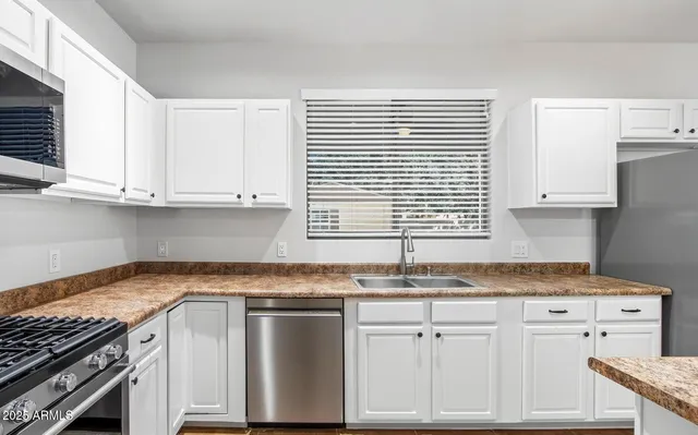 a view of an empty room with wooden floor and staircase