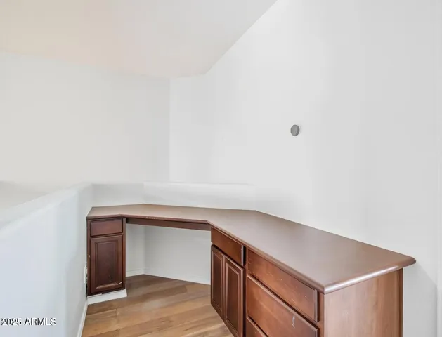 an empty room with windows and ceiling fan