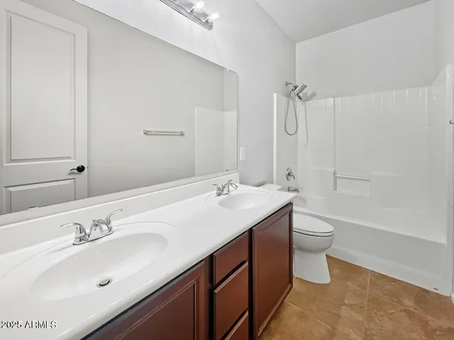 a bathroom with a tub sink and mirror