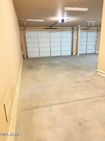 a view of a backyard with swimming pool and table under an umbrella