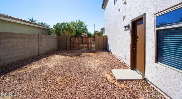 a view of a swimming pool with a table and chairs under an umbrella