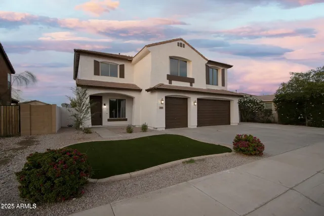 a front view of a house with a garden