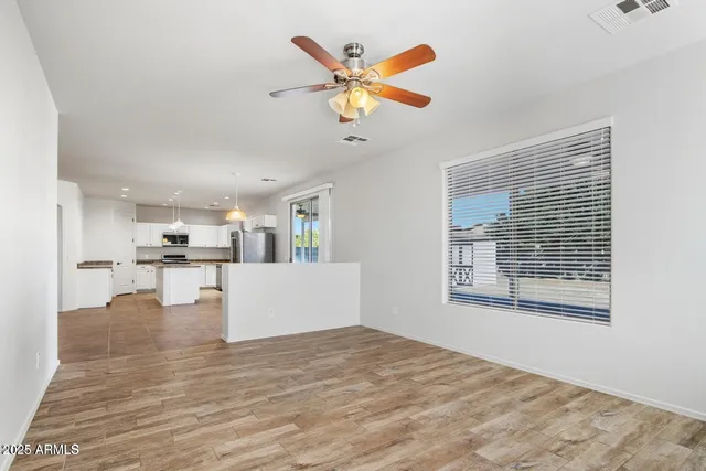 a view of kitchen and living room with wooden floor