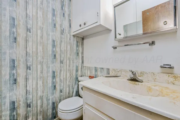 a bathroom with a sink a toilet and shower curtain