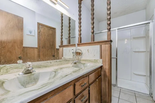 a bathroom with a granite countertop sink and a mirror