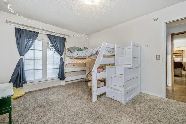 a view of an empty room with a cabinet