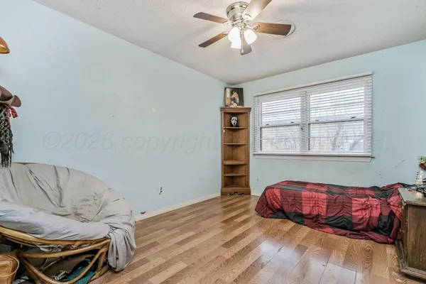 a living room with a bed furniture and a window