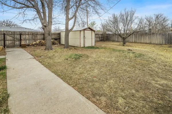 a view of a yard with a house and a tree