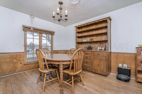 a view of a dining room with furniture wooden floor and chandelier