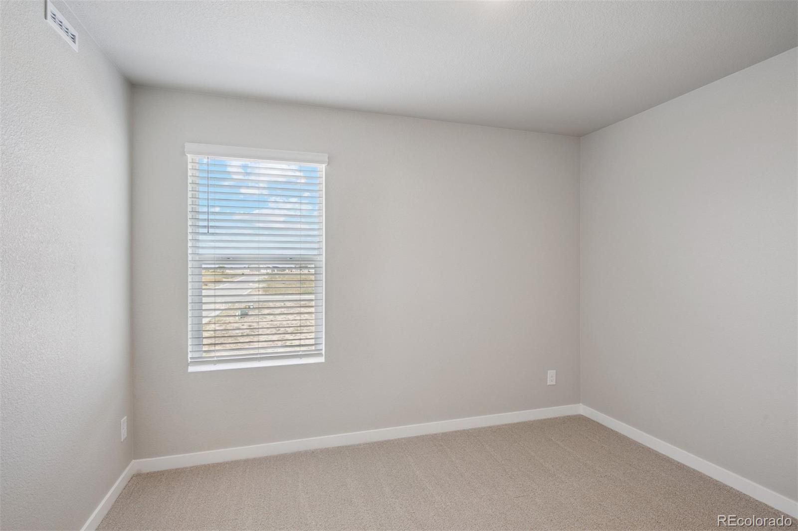 930 Montbello Avenue Fort Lupton, CO 80621 - Photo 14 of 40 an empty room with a window