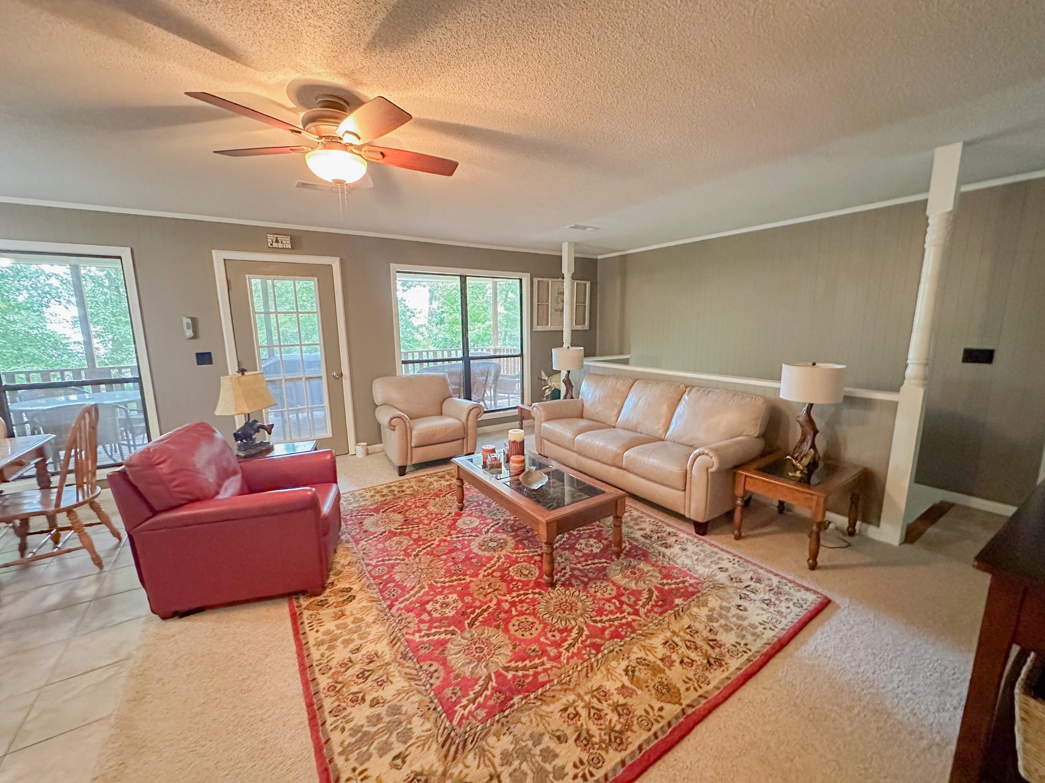 15 Cr 443 Road Iuka, MS 38852 - Photo 4 of 21 Living room with a textured ceiling, ornamental molding, ceiling fan, and tile patterned floors