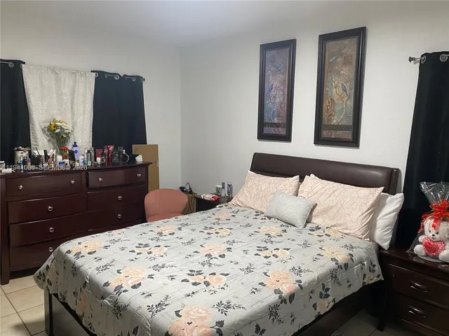 a bedroom with a bed and a mirror