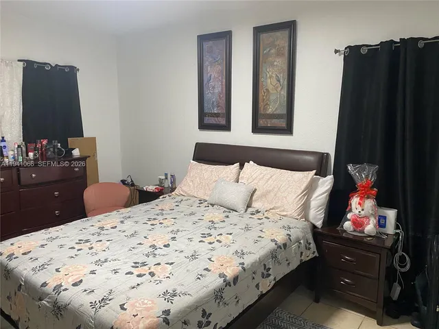 a bedroom with a bed and dresser