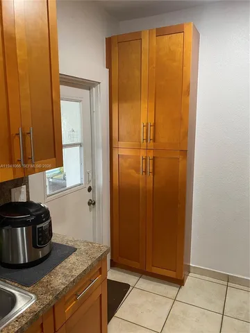 a kitchen with a refrigerator and cabinets