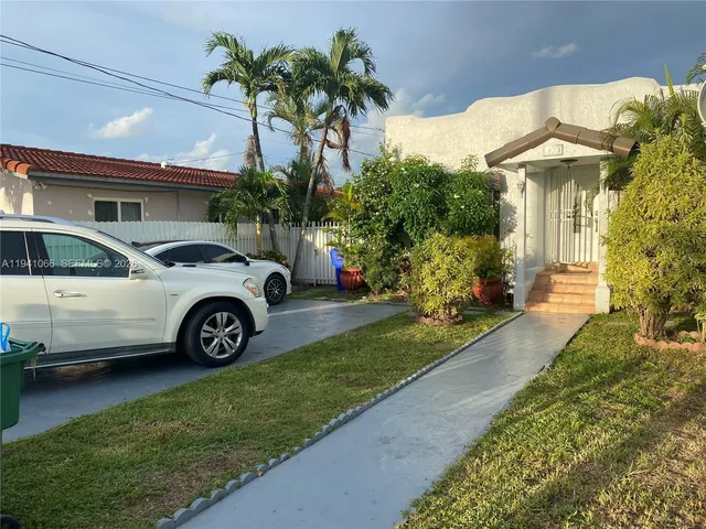 a view of a car parked in front of a house