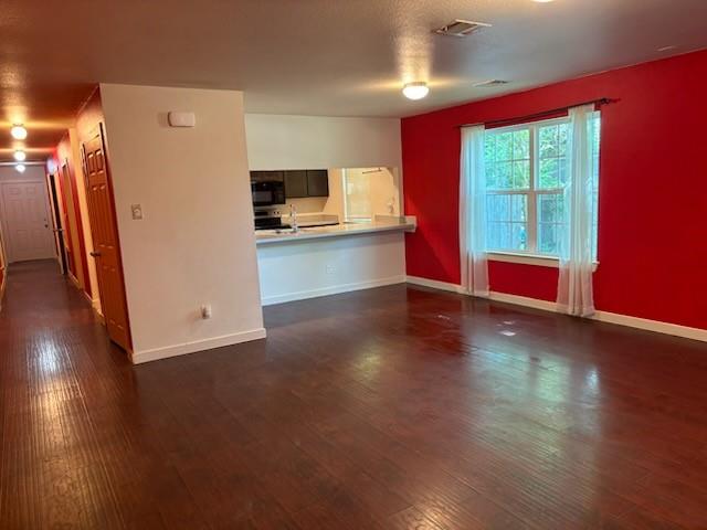 4744 Stokes Street Dallas, TX 75216 - Photo 2 of 20 a view of a kitchen with a refrigerator and wooden floor